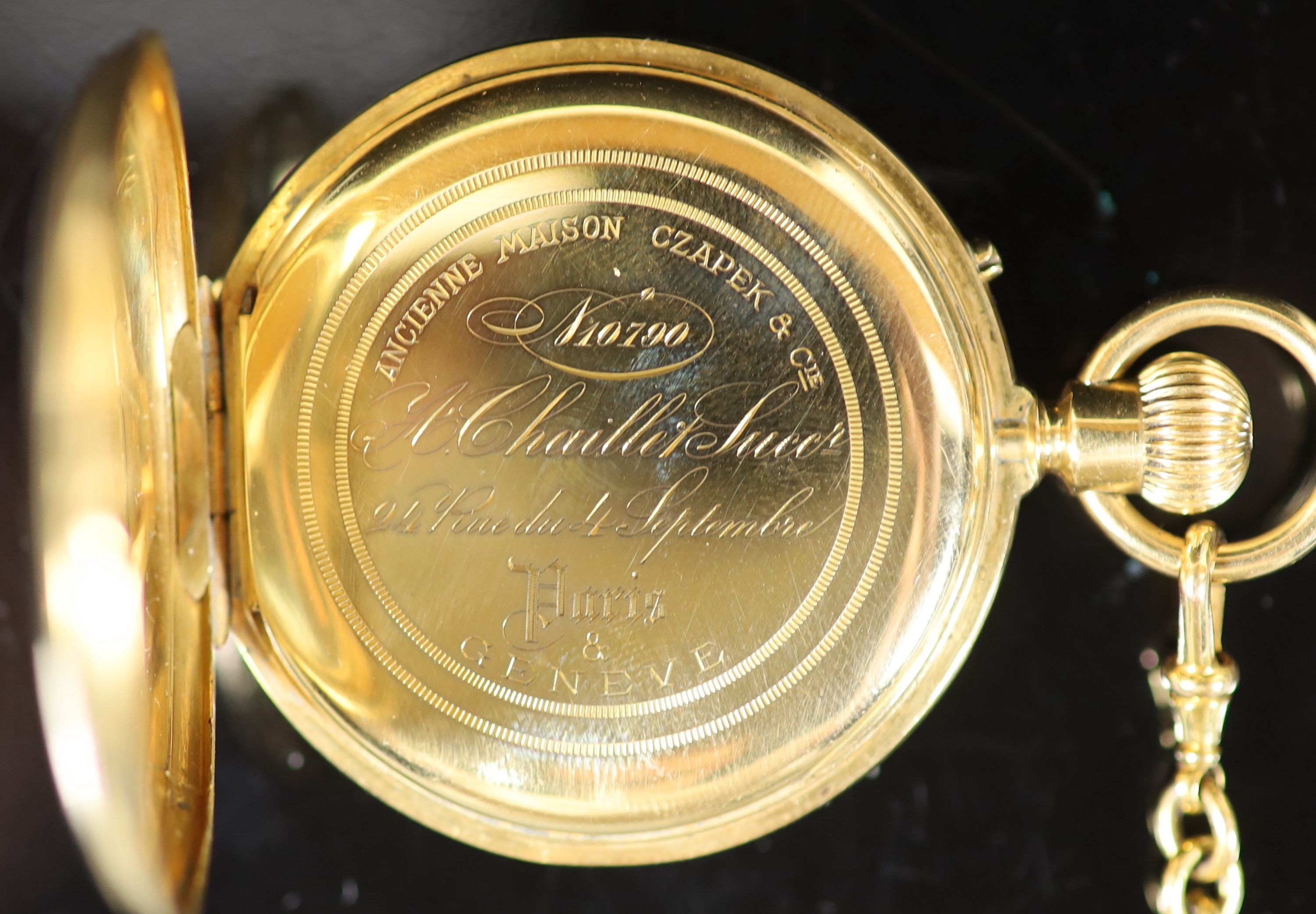 An 18ct gold full hunter keyless lever pocket watch, having white enamel Roman dial with subsidiary seconds dial, engraved monogram, on a 9ct mounted black silk ribbon, with 9ct and amber swivelling fob